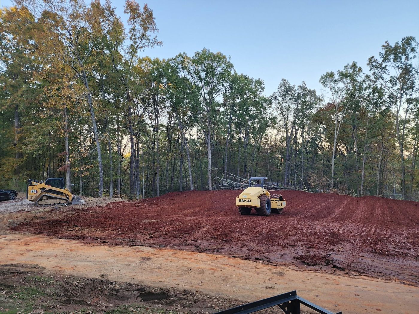 Sakai roller compacting red clay fill