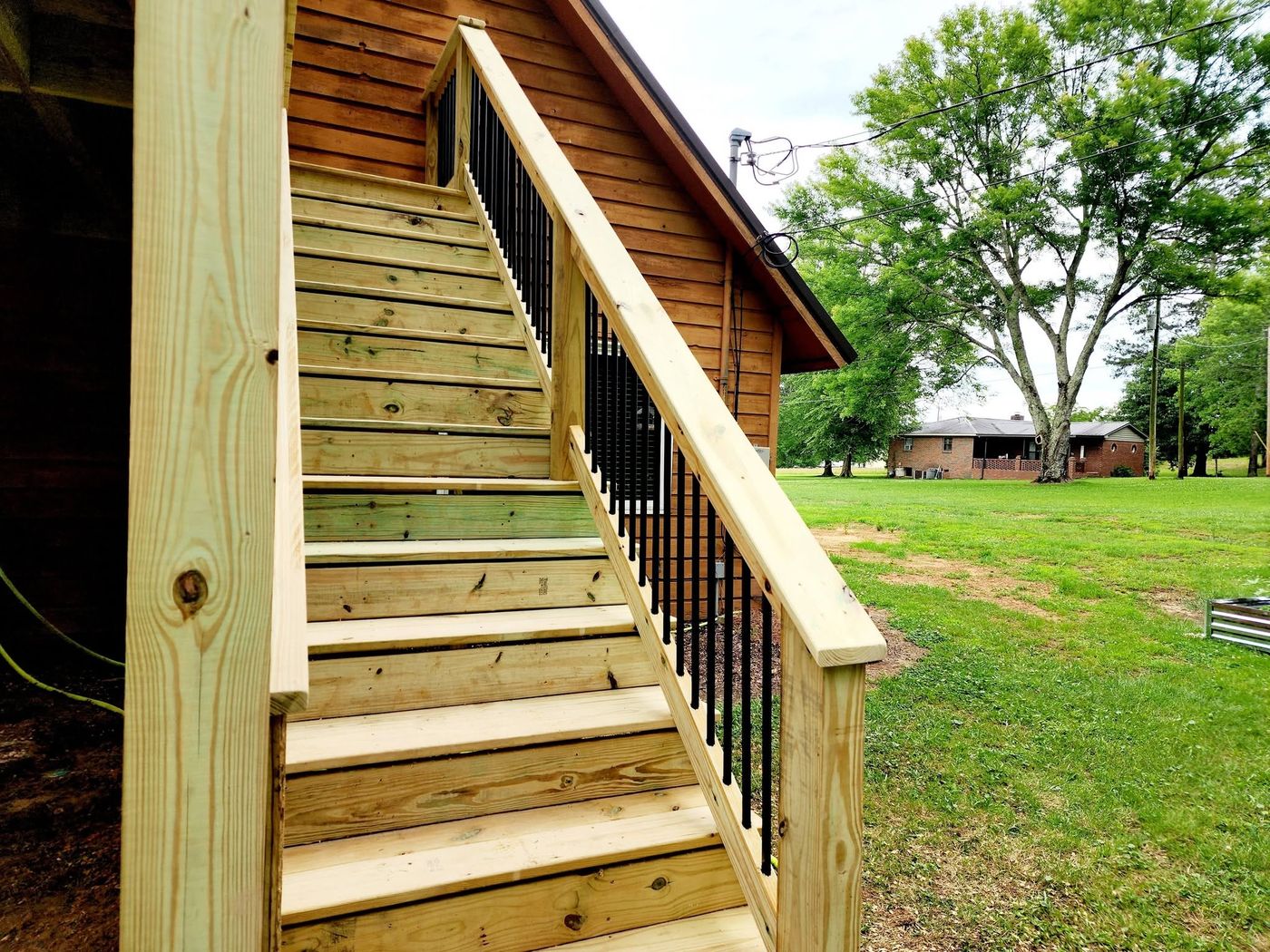 Close-up of new deck staircase with metal balusters