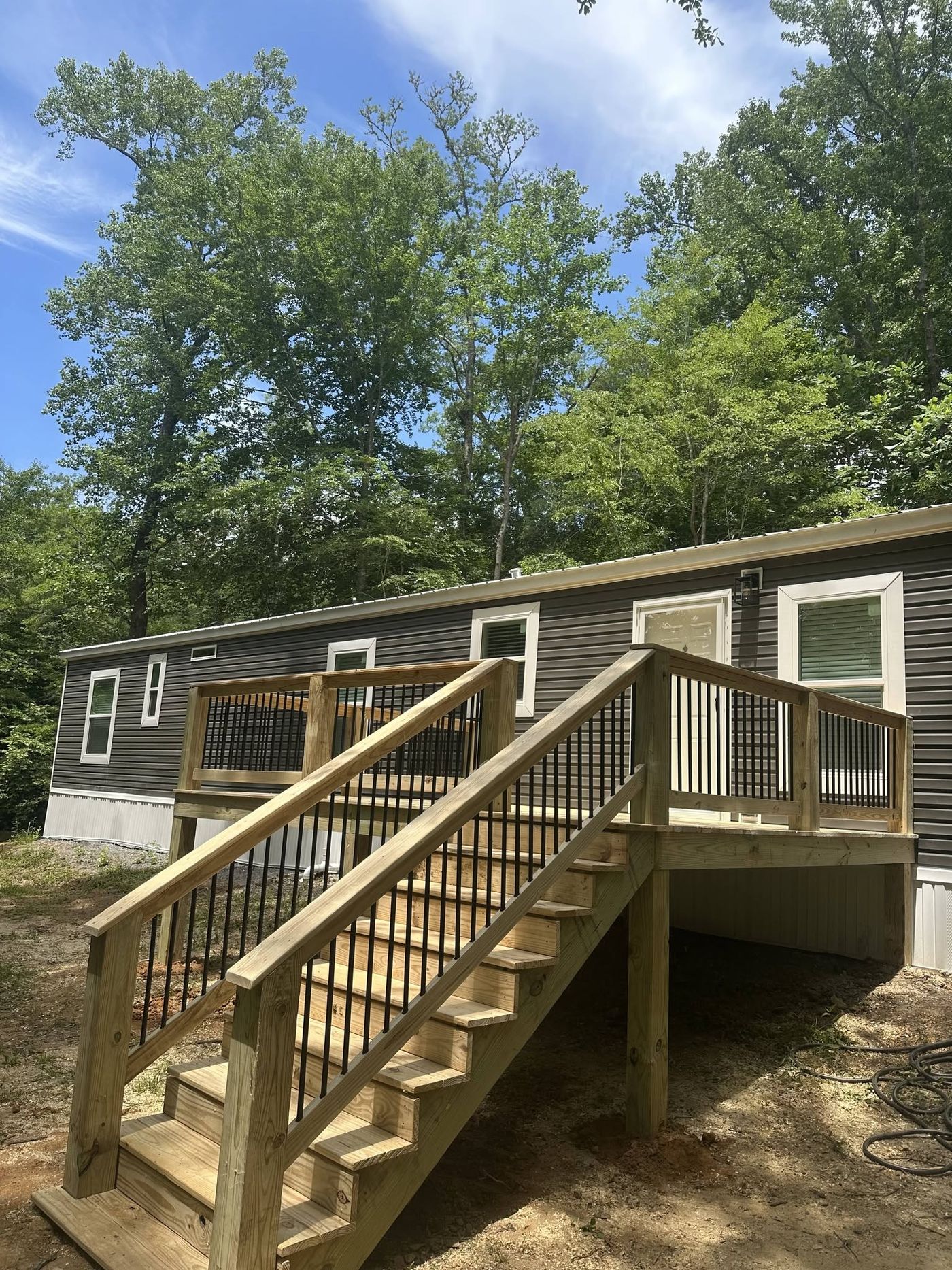 Deck and staircase with black balusters on a new manufactured home