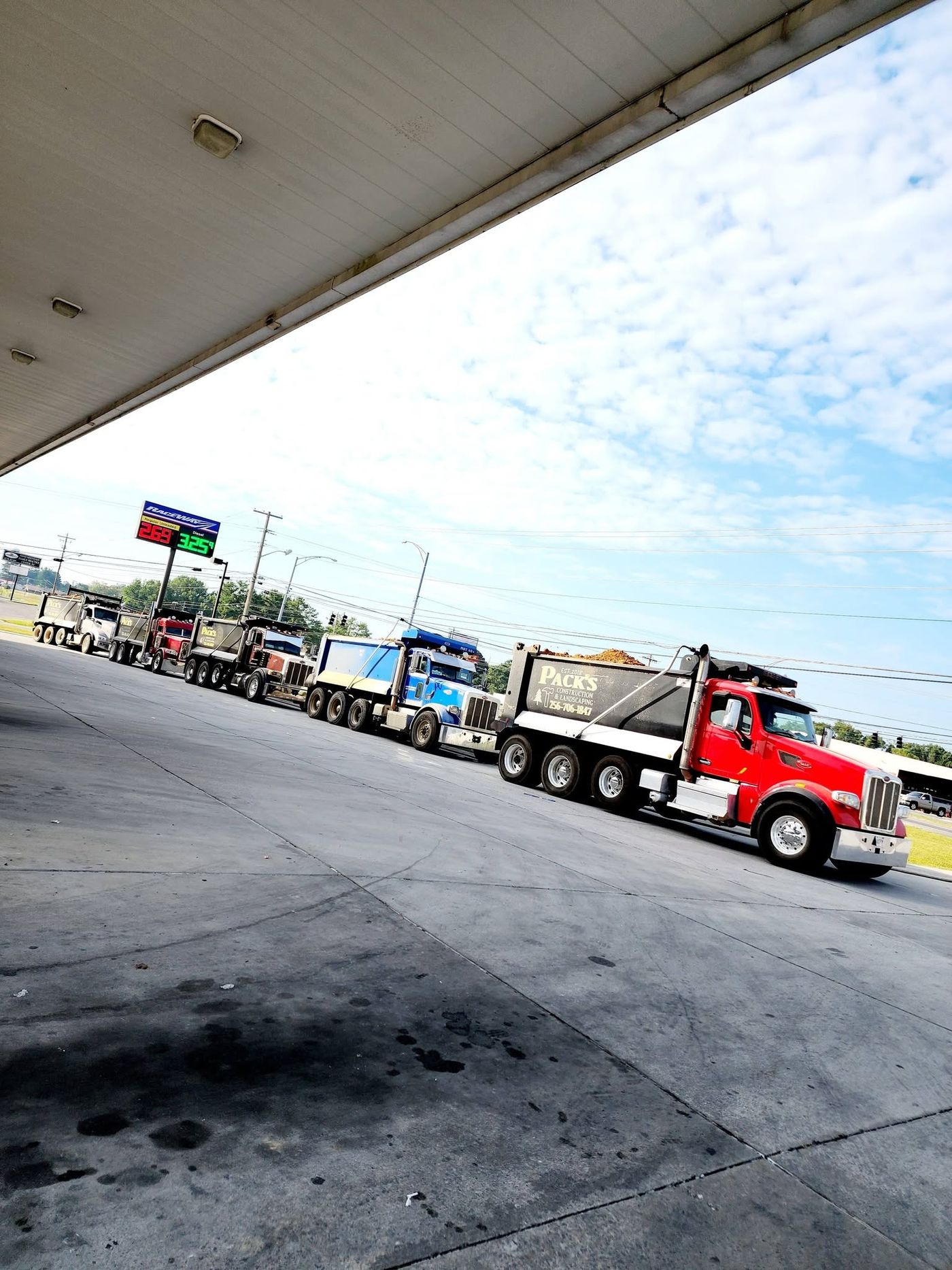 Pack's dump truck convoy lined up at the fuel pumps