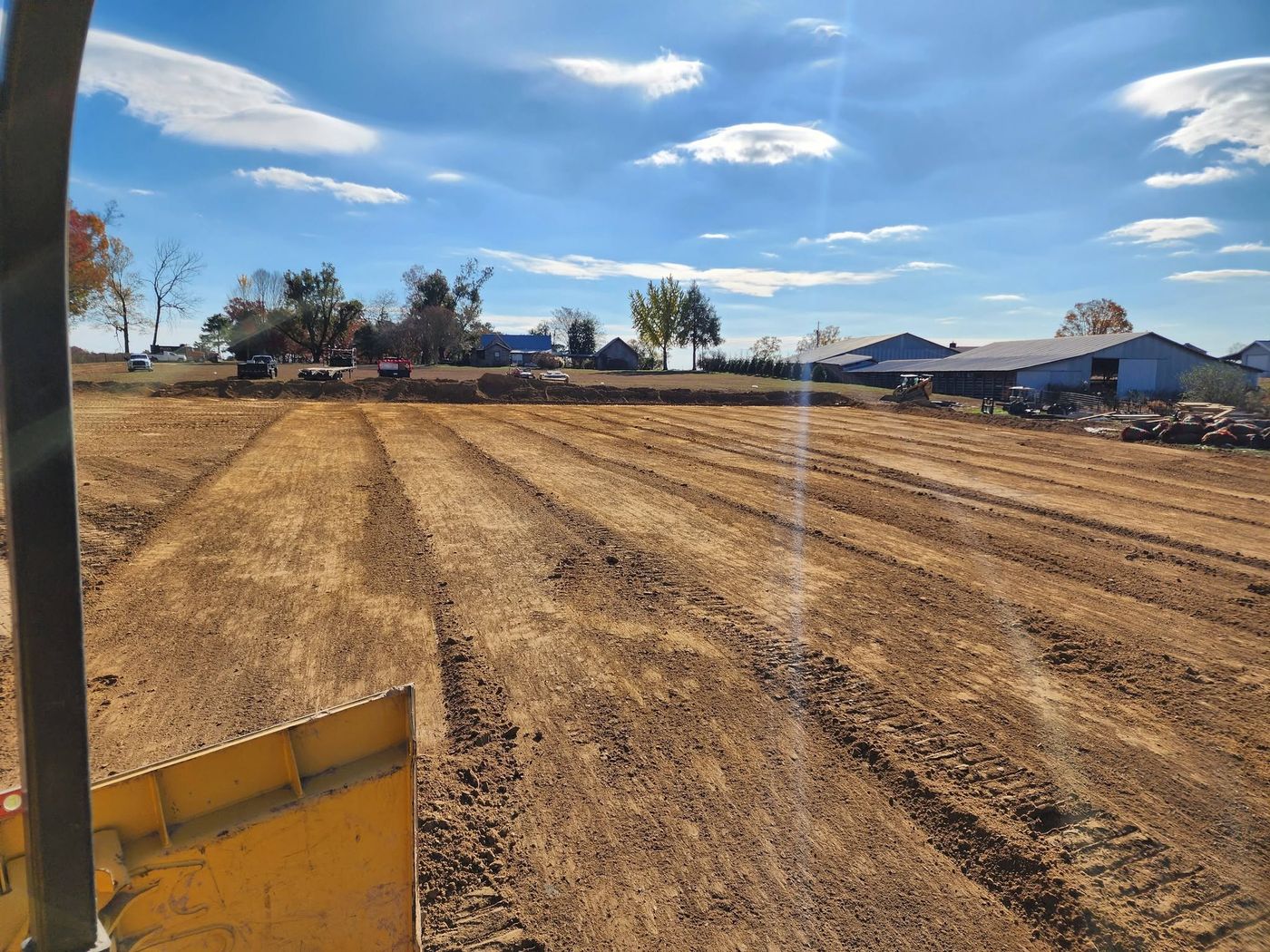 Farm building pad graded, seen from the dozer seat