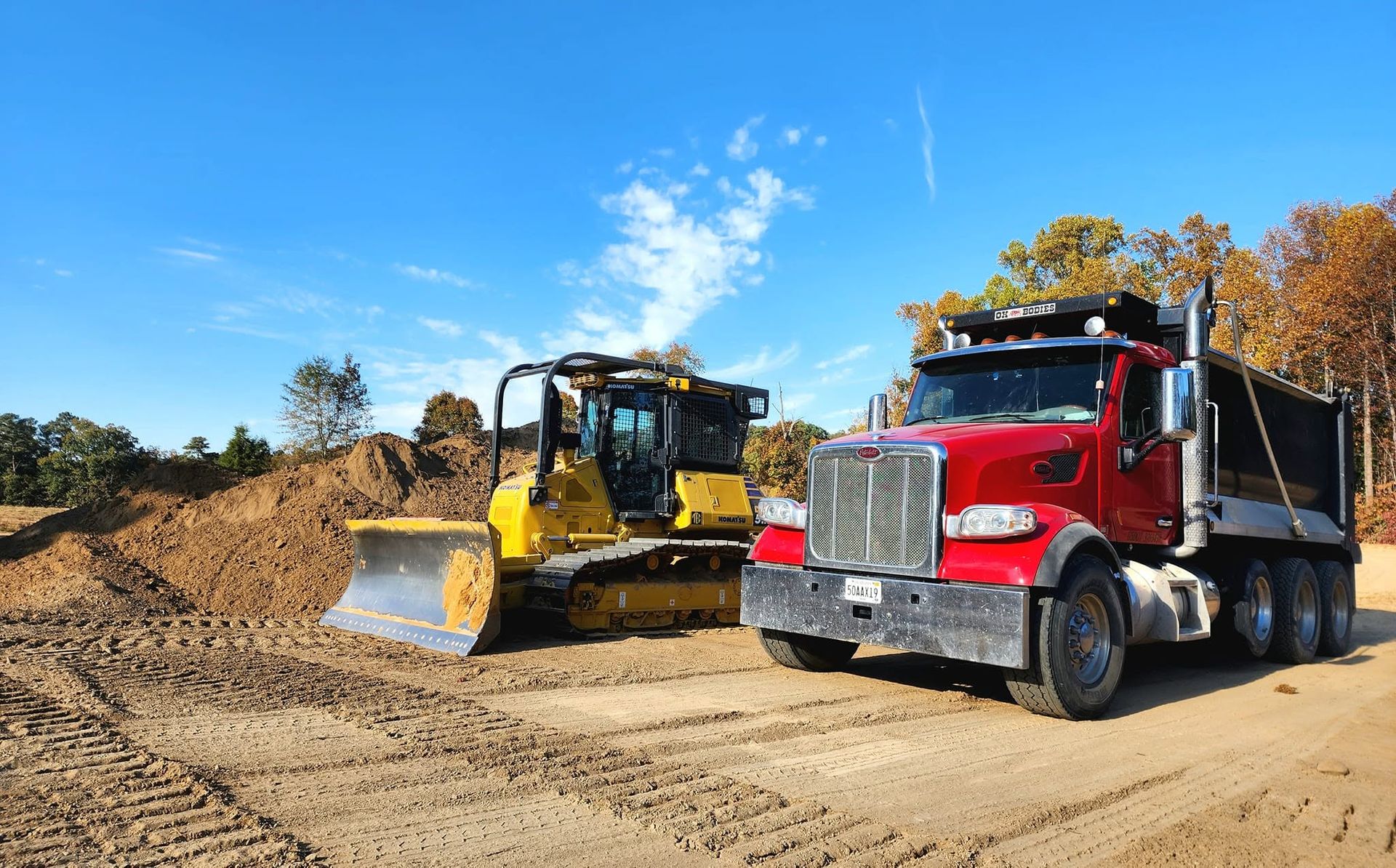 Pack's Construction dump truck and Komatsu dozer on a grading job in north Alabama