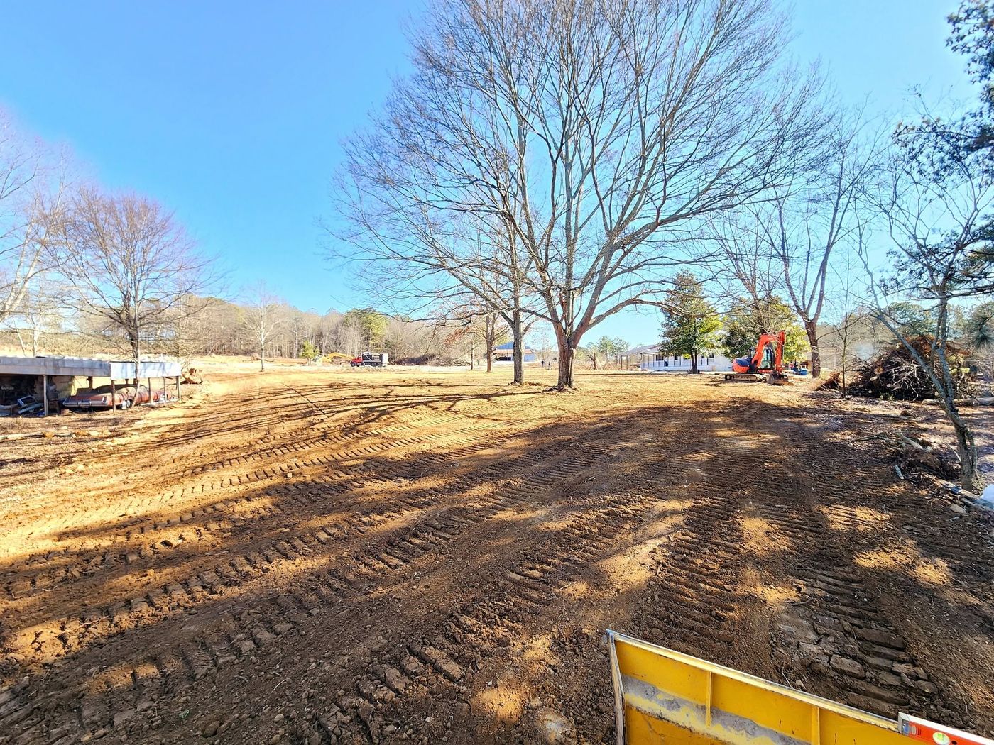 Lot cleared and graded by Pack's with excavator on site