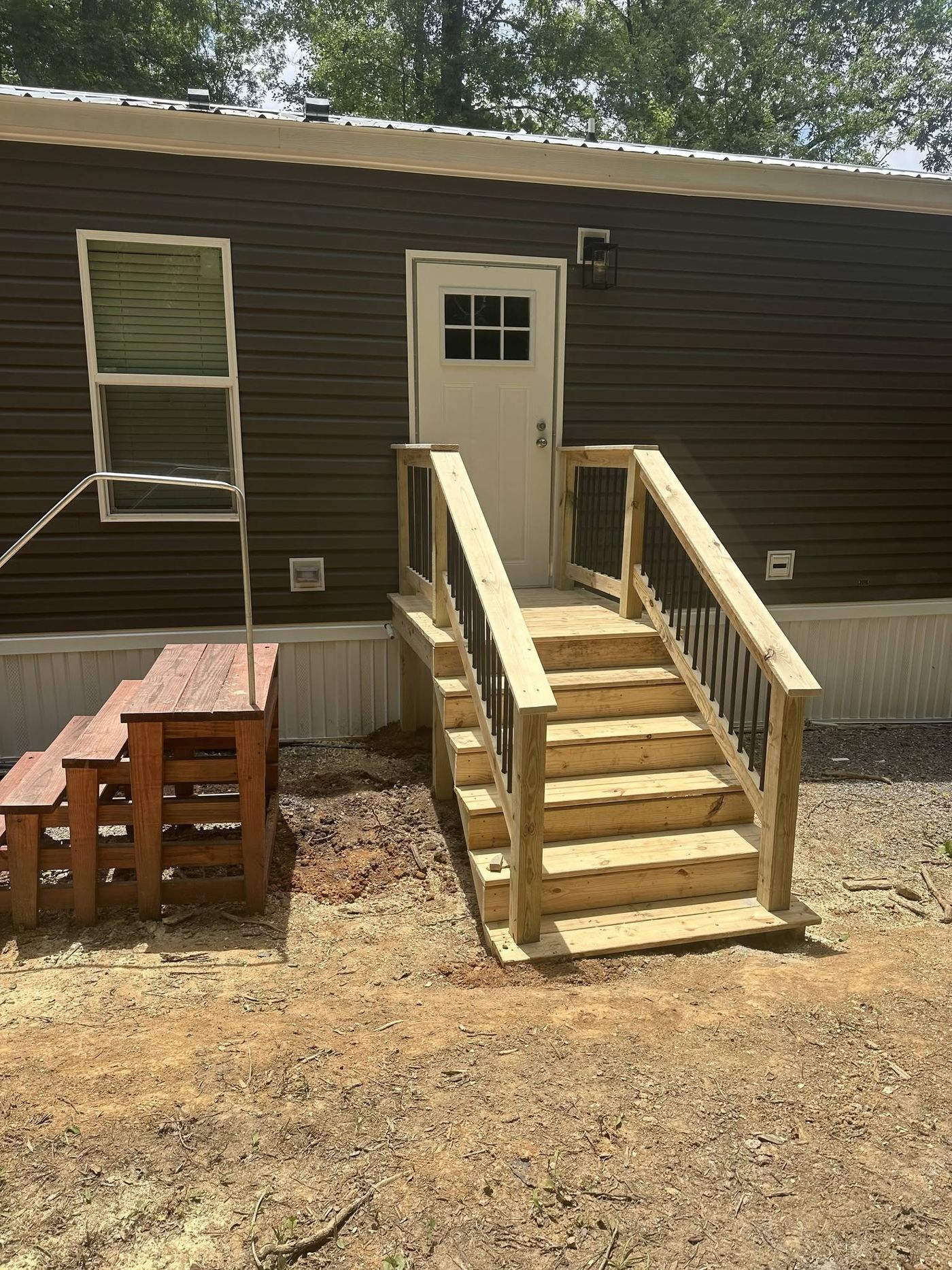 New porch steps and railing replacing worn-out wooden stairs