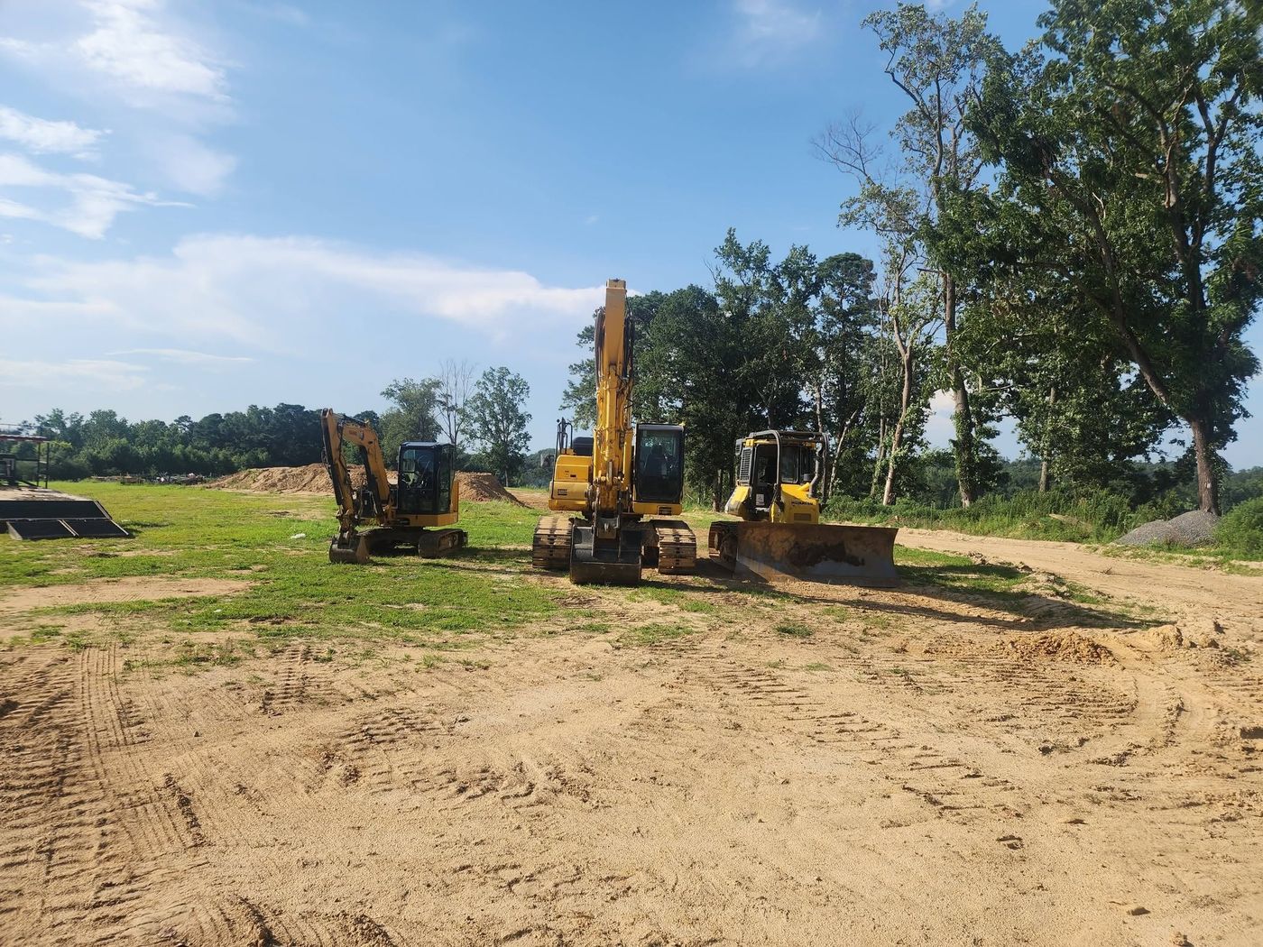 Mini excavator, excavator and dozer staged on a job site